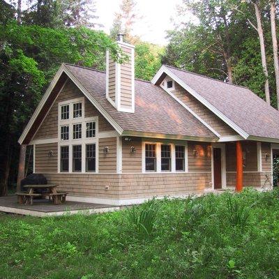 Cottage exterior on wooded lakefront lot  