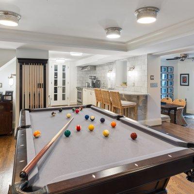 renovated basement billiards table new kitchenette modern lighting